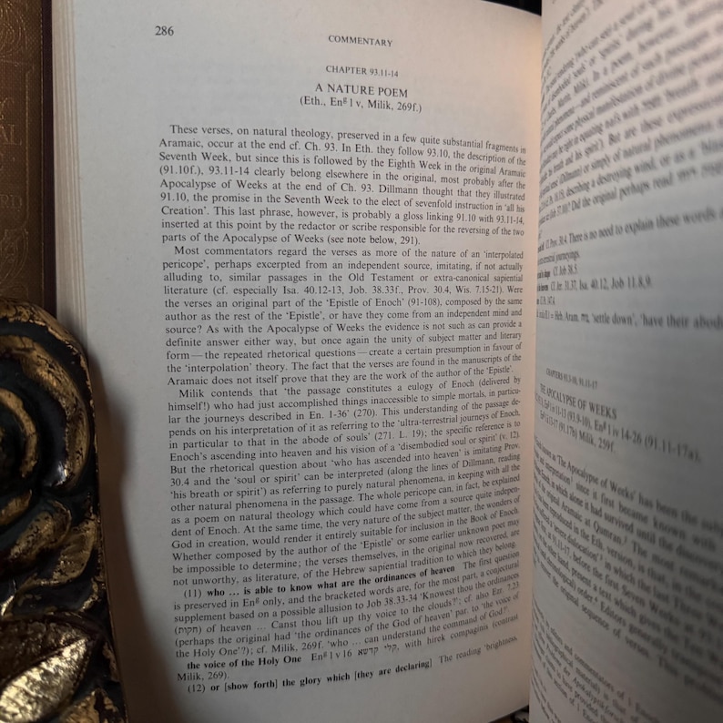 May include: An open book with text on the pages. The text is in English and discusses religious topics. The book is open to a chapter titled "A Nature Poem". The page numbers are visible.