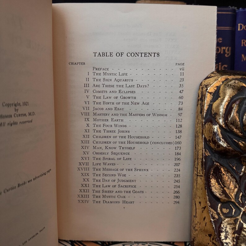 May include: A black and white book with a table of contents for a book titled "The Mystic Life". The table of contents lists chapters with page numbers. The book is open to the table of contents page.