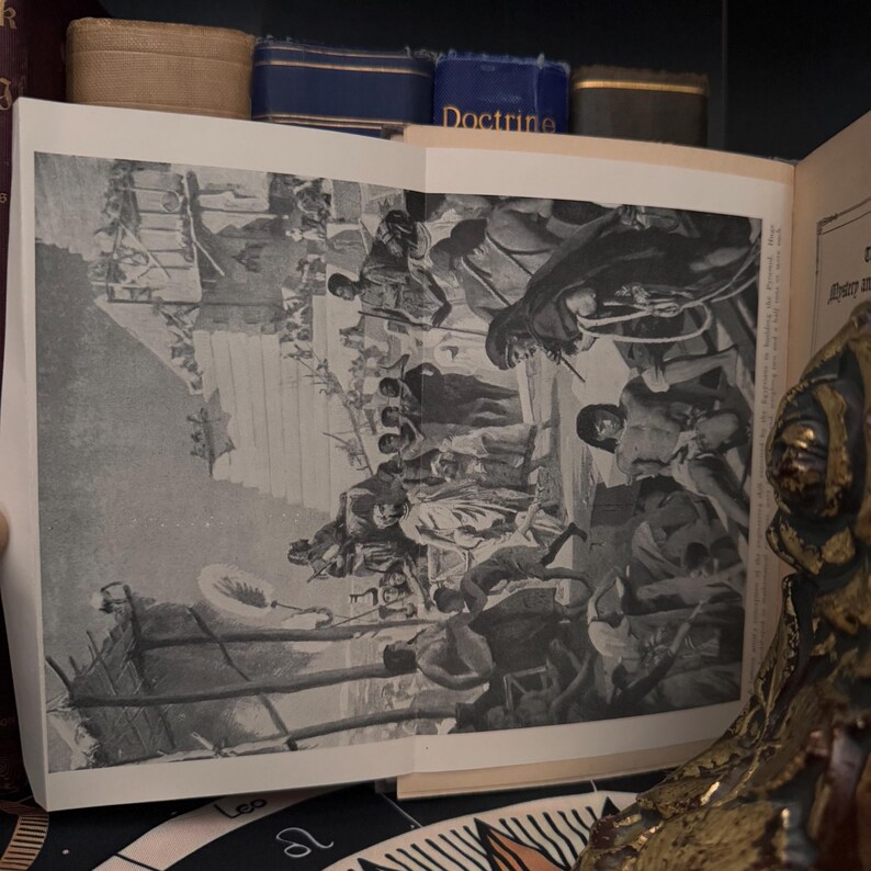 May include: Black and white illustration of a historical scene depicting a group of people in a crowded marketplace. The image is from an old book and has a vintage feel.