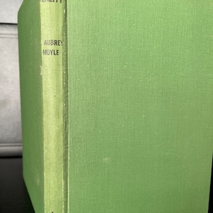 May include: A green hardcover book titled "Reality" by Aubrey Moyle. The book is published by Reed.