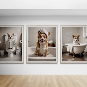 May include: Three framed prints of a corgi dog in different bathroom settings. The first print shows the corgi sitting on a toilet reading a newspaper. The second print shows the corgi sitting in a bathtub wearing a towel on its head. The third print shows the corgi sitting in a bathtub with a rubber ducky.