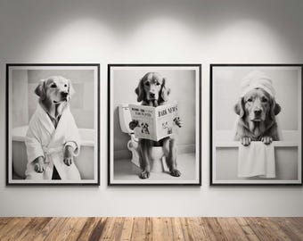 May include: Set of three framed black and white prints featuring Golden Retrievers in humorous bathroom scenes. One dog wears a bathrobe, another reads a newspaper on a toilet, and the third has a towel on its head in a bathtub.