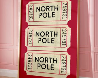 May include: A framed vertical print featuring three stacked cream-colored admission tickets against a solid red background. Each ticket displays the black text NORTH POLE and the number 249731 printed vertically on both the left and right sides.