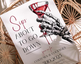 May include: White invitation card with a skeleton hand holding a cocktail glass with dripping red liquid. Text reads "Sips About to Go Down" and "Costumes & Cocktails 31.10.2025". The card is set on a woven basket.