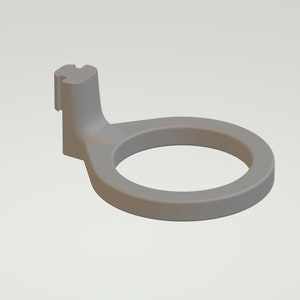 May include: A grey plastic ring with a small, vertical, rectangular tab on the side. The ring is designed to hold a small object, such as a key or a bottle opener.
