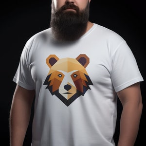 May include: A white t-shirt featuring a geometric bear design in shades of brown, orange, and yellow. The bear has a black nose and eyes.