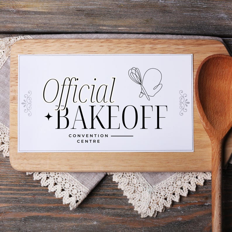 May include: A white sign with black text that reads "Official Bakeoff Convention Centre" on a wooden cutting board with a wooden spoon.