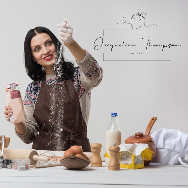 May include: A woman in a brown apron and a white sweater is sprinkling flour from a bag. She is standing in a kitchen with a white countertop and various baking supplies, including a bowl, a rolling pin, eggs, and a chef's hat.