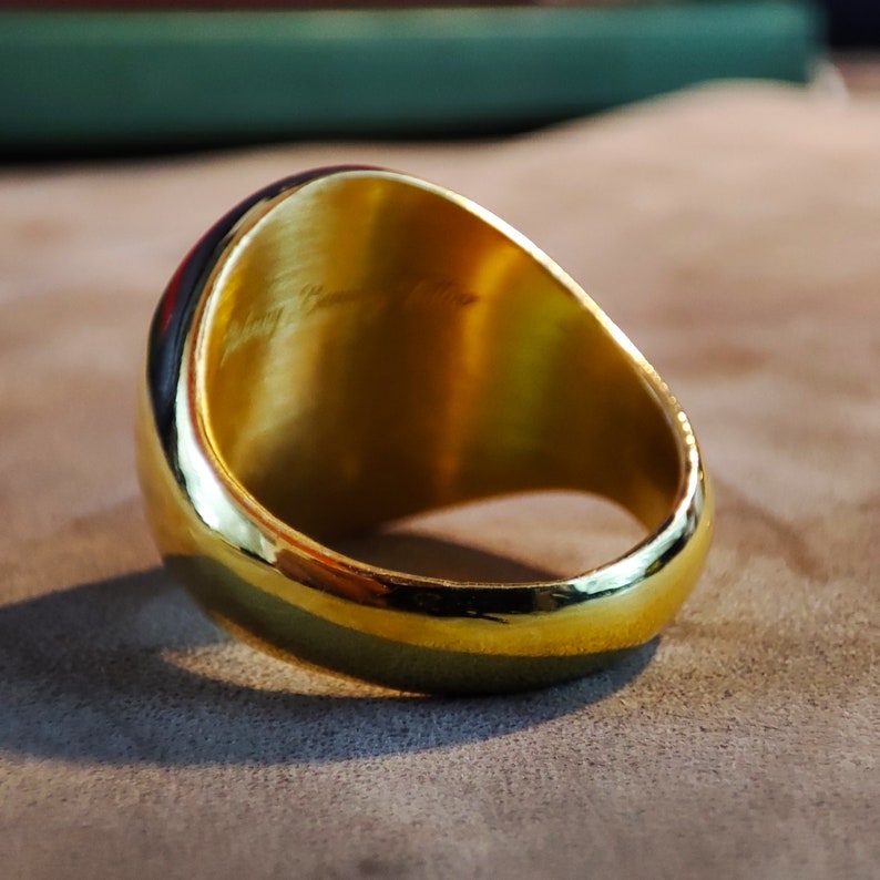 Shown here is a personalized monogram signet ring with engraved initials centered on its smooth top. The craftsmanship highlights clean lines, a polished finish, and a traditional signet form. Available in Silver, Gold Plated, and 14k Gold, the ring suits both men and women. The image captures the elegant engraving and strong build, making it an ideal choice as a meaningful Christmas gift or personalized accessory for everyday wear.