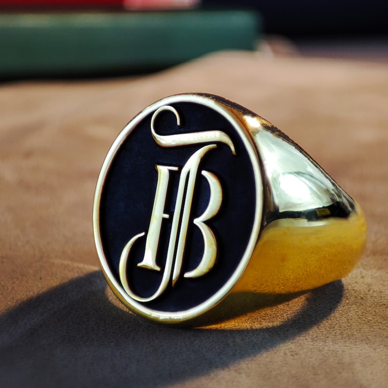 This detailed photograph shows a personalized initial signet ring with a custom monogram engraved on its face. Available in Silver, Gold Plated, and 14k Gold, the ring blends luxury with personal meaning. The engraving is precise and balanced, demonstrating expert craftsmanship. The polished surface reflects light smoothly, highlighting the ring’s quality. This image emphasizes the item’s suitability as a Christmas gift for men or women seeking meaningful jewelry.