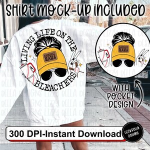 May include: A white sweatshirt with a graphic design that says "Living Life on the Bleachers" with a baseball and a baseball mom graphic. The graphic is in yellow, black, and red. The text "With Pocket Design" is on the right side of the image.