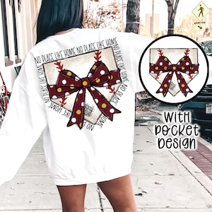 May include: White sweatshirt with a baseball home plate design. The design features a maroon bow with white polka dots and the text "NO PLACE LIKE HOME". A smaller version of the design is on the pocket. The words "With pocket design" are also visible.