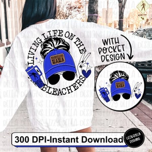 May include: A white sweatshirt with a blue and brown graphic design that says "Living life on the bleachers with pocket design". The graphic features a woman with a messy bun wearing a blue baseball cap with the words "Wrestling Mama" on it.