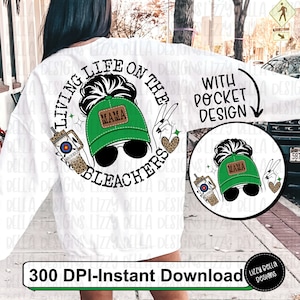 May include: White sweatshirt with a green and black design that says "Living life on the bleachers" with a woman wearing a green baseball cap that says "Mama" and sunglasses. The design also includes a drink with a straw and a leopard print design. The text "With pocket design" is also included.