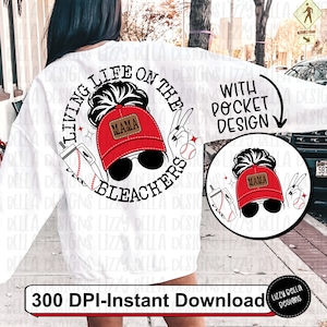 May include: A white sweatshirt with a black and white graphic design that says "Living Life on the Bleachers" with a baseball, a drink, and a woman wearing a red baseball cap that says "Mama". The design is also available as a pocket design.