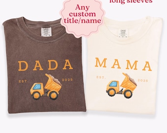 May include: Two t-shirts in espresso and ivory colors. The espresso shirt features the text DADA EST. 2025 with a yellow dump truck graphic. The ivory shirt features the text MAMA EST. 2025 with a yellow dump truck graphic. Text includes Any custom title/name and Also available in long sleeves.