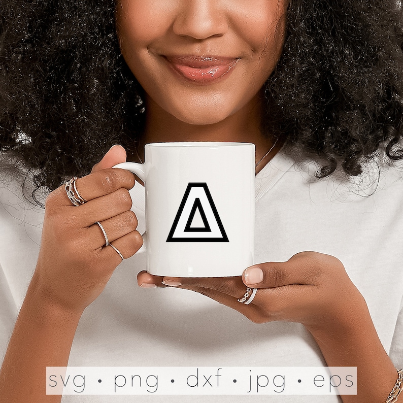 May include: A white ceramic mug with a black triangle design. The triangle is made up of two overlapping triangles.