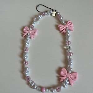 Pink bow + pearl phone charm