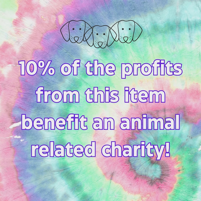 May include: A colorful tie-dye background with three dog head outlines at the top. Text in purple reads "10% of the profits from this item benefit an animal related charity!"
