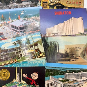 May include: A collection of vintage postcards featuring various scenes including the Comstock RV Resort, Trader Dick's Casino, a Sheraton hotel, a beach resort with a pool, a shopping center, and a building with a Gold Medallion Home award graphic.