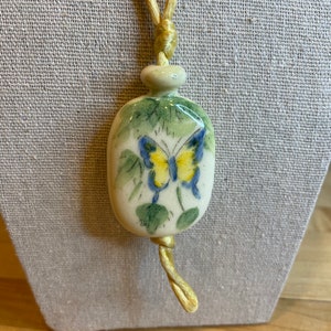 Vintage 70s Avon Ceramic Butterfly Pendant Necklace Yellow Cord Hand Painted. Made in Brazil.
