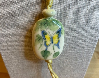 Vintage 70s Avon Ceramic Butterfly Pendant Necklace Yellow Cord Hand Painted. Made in Brazil.