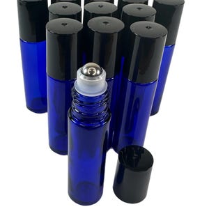 May include: A group of 10 ml cobalt blue glass roller bottles with black caps. The bottles are arranged in a pyramid shape with one bottle in the front and the rest behind it.