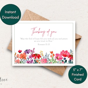 May include: A white greeting card with the text "Thinking of you" in red script, featuring a floral watercolor design. The card is 12.7cm x 17.8cm and includes a Bible verse. An envelope is behind the card.