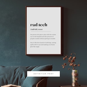 May include: A framed definition print with the words "rad tech" in bold black font. The definition describes a radiology technician. The print is displayed on a dark teal wall above a teal couch and a glass vase with decorative branches.