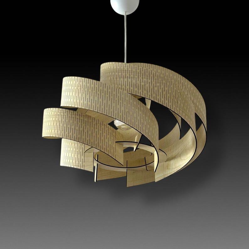 May include: A modern, spiral-shaped pendant light fixture made of light-colored wood. The fixture has a series of curved, layered panels with small, vertical cutouts. A white ceiling mount and cord support the light, which hangs against a dark background.