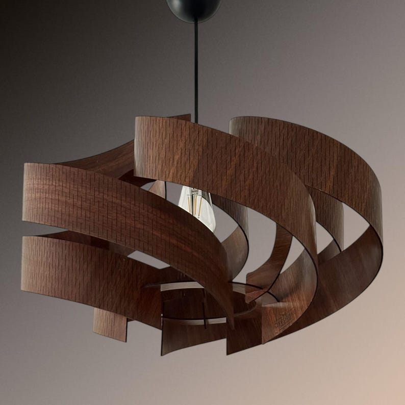 May include: A modern pendant light fixture with a unique design. The light features curved, wooden slats in a dark brown color, arranged in a spiral pattern around a central light bulb. The fixture hangs from a black cord and ceiling mount.