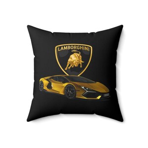May include: Black pillow with a gold Lamborghini logo and a gold Lamborghini car on it.