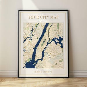 May include: A framed city map print with a black frame. The map features a beige and blue color scheme, with the text "YOUR CITY MAP" at the top. The map includes the coordinates 40.780° N | 73.960° W.