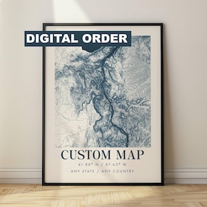 May include: A framed custom map print with a topographic design in shades of blue. The text "DIGITAL ORDER" is at the top, and "CUSTOM MAP" is displayed below the map. Coordinates 41.88° N / 87.63° W and "ANY STATE / ANY COUNTRY" are also included.
