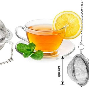May include: Two silver tea infusers with a chain and hook. The infuser is a sphere with a fine mesh. The infuser is 1.69 inches in diameter.