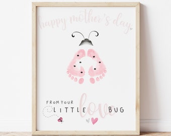 May include: Pink and white printable art print with a ladybug made from baby footprints. The text reads "Happy Mother's Day" and "From your little love bug".
