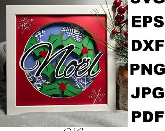 May include: A white frame with a red background and a blue circle containing the word "Noël" in black script with green holly leaves and red berries. The frame is decorated with snowflakes. The image is labelled "6 Layers".