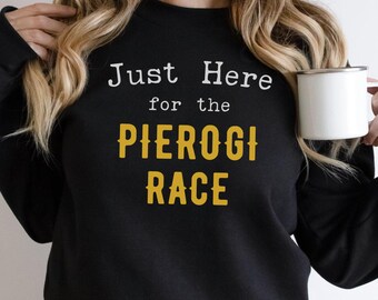 May include: Black sweatshirt with the text "Just Here for the Pierogi Race" in white and yellow lettering.