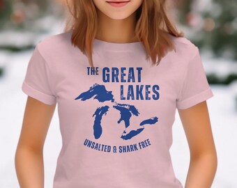 May include: A pink t-shirt with a blue graphic of the Great Lakes and the text "The Great Lakes Unsalted & Shark Free".