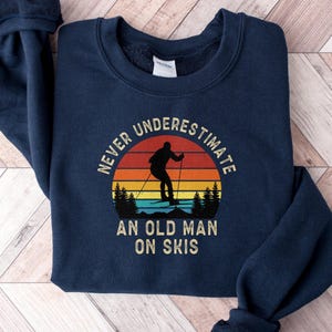 Never Underestimate an Old Man on Skis Sweatshirt, Retro Skiing Trip Long Sleeve Shirt Men, Womens Ski Clothes Funny Snow Skier Gift for Him