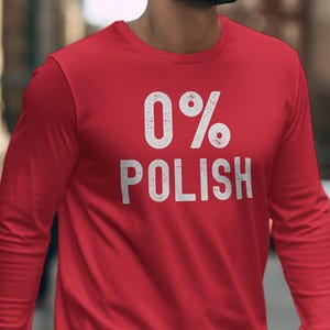 May include: Red long-sleeve shirt with white text that reads "0% Polish".