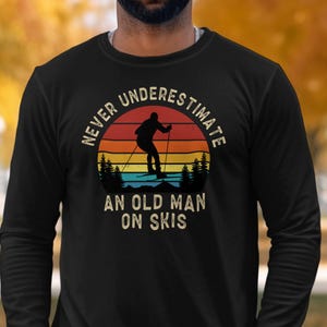 Never Underestimate an Old Man on Skis Sweatshirt, Retro Skiing Trip Long Sleeve Shirt Men, Womens Ski Clothes Funny Snow Skier Gift for Him