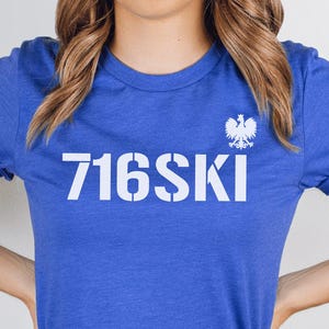 May include: A royal blue t-shirt with a white graphic of the number 716SKI and a white eagle emblem.