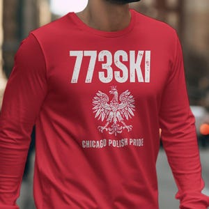 May include: Red long-sleeve shirt with white text that reads "773SKI" and "CHICAGO POLISH PRIDE". A white graphic of a Polish eagle is centered below the text.