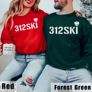 May include: Two matching sweatshirts, one red and one forest green, with the text "312SKI" and a white eagle graphic on the front.