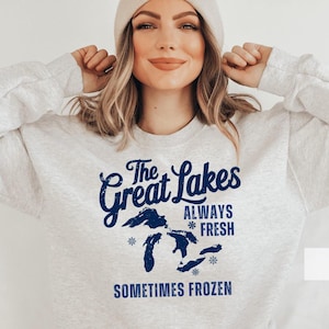 May include: A gray sweatshirt with a blue graphic of the Great Lakes. The graphic includes the text "The Great Lakes Always Fresh Sometimes Frozen".