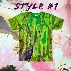 May include: Green and purple tie-dye t-shirt with a light green background and a darker green and purple pattern. The shirt has a crew neck and short sleeves. The text "STYLE #1" is visible in the top center of the image.