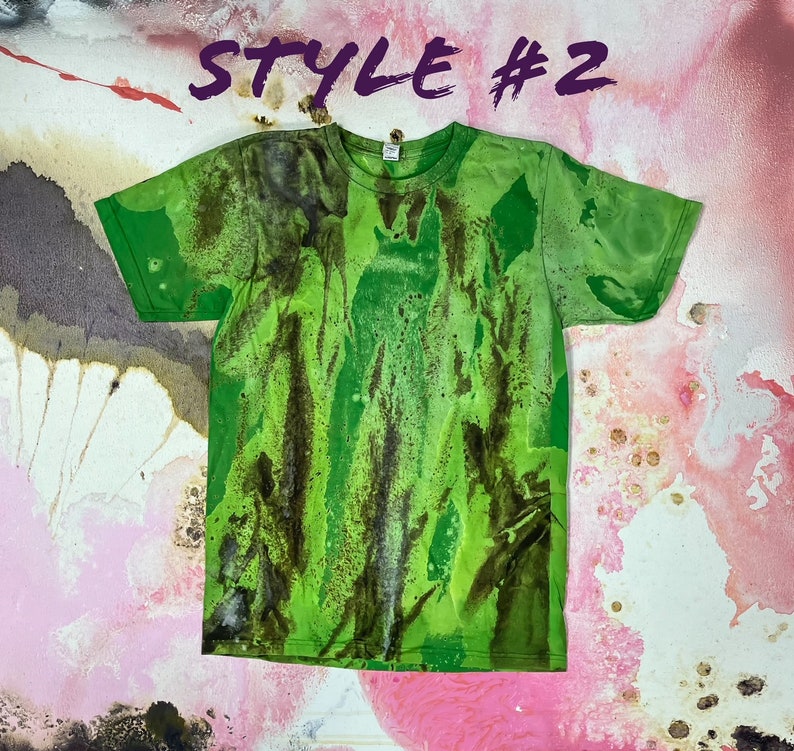 May include: Green t-shirt with a tie-dye pattern in shades of green and brown. The shirt has a crew neck and short sleeves. "Style #2" is written in purple at the top of the image.