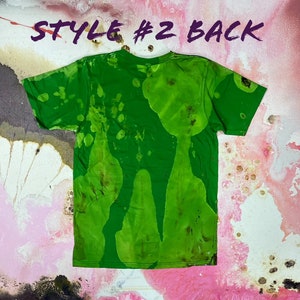 May include: Green t-shirt with a tie-dye pattern. The back of the shirt has a green, brown, and white pattern. The shirt is labeled "Style #2 Back".