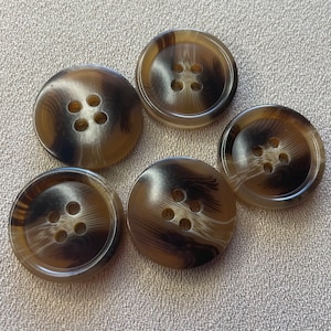 May include: Five brown and black patterned buttons with four holes each. The buttons have a swirl pattern and are made of a smooth material.